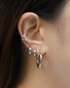 achieve a multi-piercing stacked look with our triple banded bejeweled ear cuff in silver