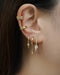 curated ear stack inspo by the hexad featuring jemma ear cuff, stellar ear cuff and the icicle ear party set of three in gold