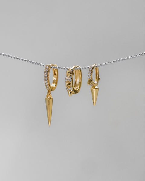 elevate your holiday ear stack with the spike ear party set of three huggie hoop earrings in gold