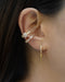 mismatched esme ear cuffs with baguette diamonds in gold by the hexad