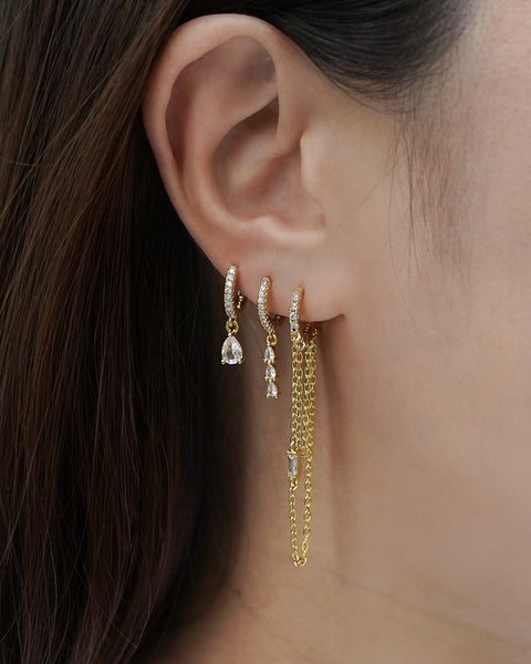 stackable ear party earring pieces embellished with diamonds and cascading chains for bold and glam look